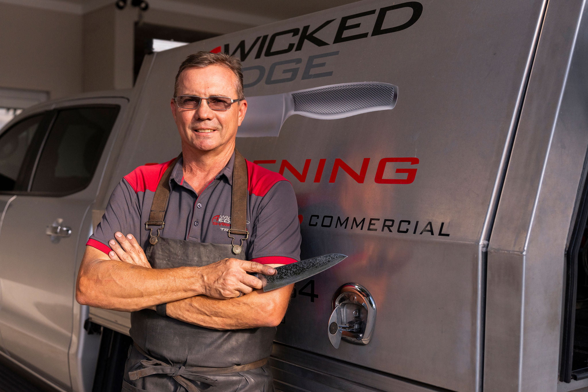 Business owner standing next to his vehicle.